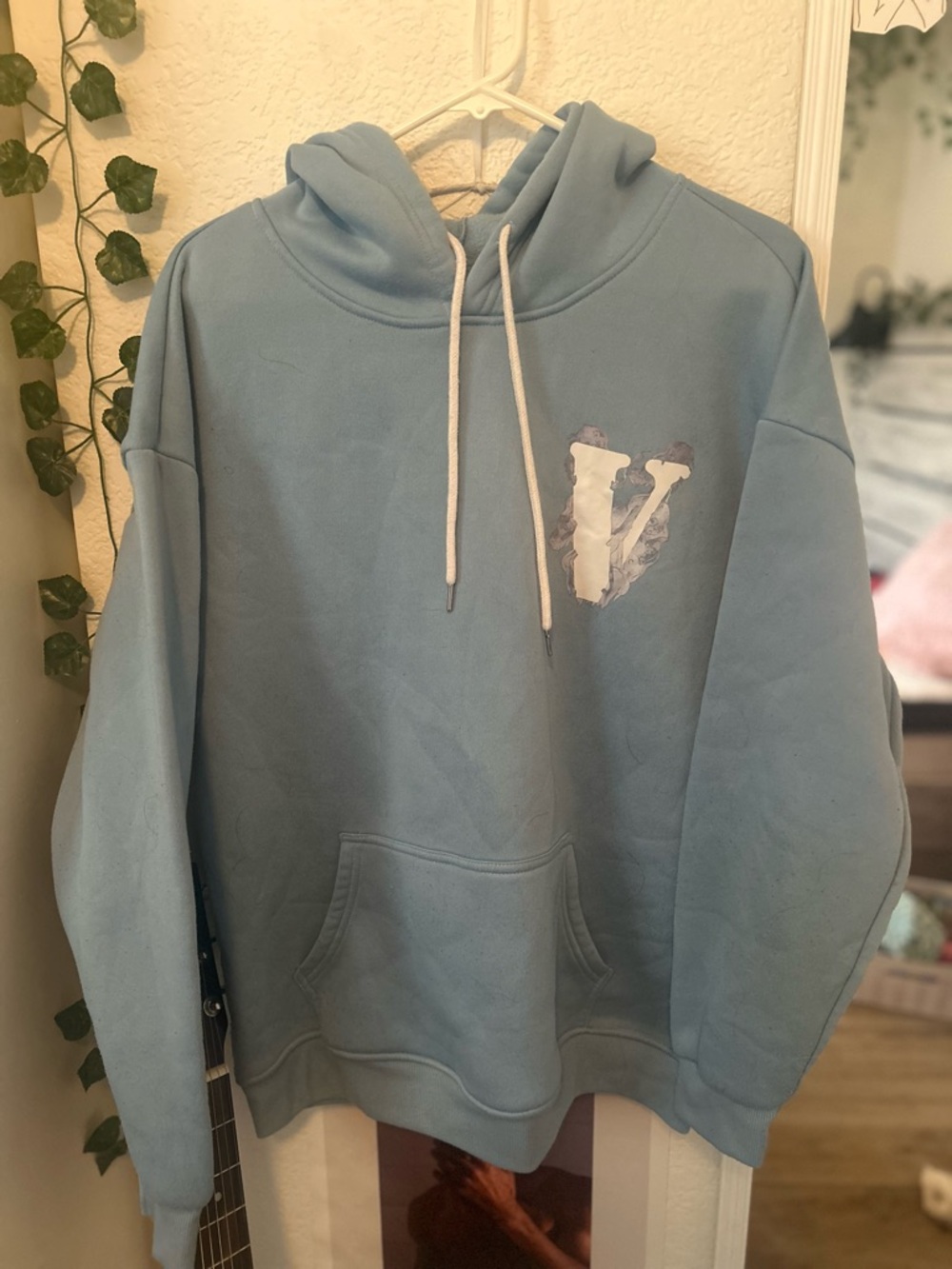 Light Blue Hoodie with White 'V' Graphic